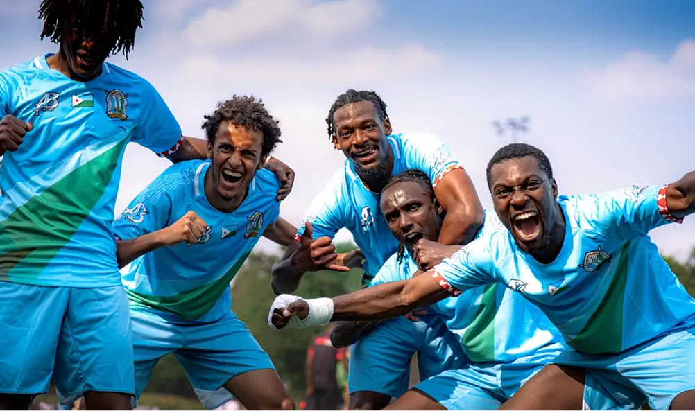 A team of footballers celebrating together